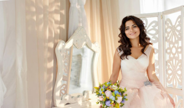 A beautiful young bride in a dress holding a bouquet AI-generated content may be incorrect.